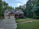 Inviting home featuring a well-manicured lawn and a two-car garage at 57 Deer Creek Run, Moreland, GA 30259