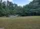Landscaped front yard with a long driveway and a basketball hoop at 57 Deer Creek Run, Moreland, GA 30259