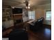 Living area with brick fireplace, custom built-ins, and dark, gleaming hardwood floors at 57 Deer Creek Run, Moreland, GA 30259