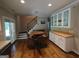 View of a living room area featuring hardwood floors, a table with chairs, and staircase at 57 Deer Creek Run, Moreland, GA 30259