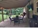 Covered patio with a tv, grill, and comfortable seating at 57 Deer Creek Run, Moreland, GA 30259