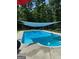 Sparkling swimming pool with shade covering provides a serene outdoor oasis at 57 Deer Creek Run, Moreland, GA 30259