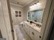 Beautiful bathroom with double sinks, a stone countertop, and decorative wall art at 2220 Cambridge Hill Ct, Dacula, GA 30019