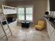 Bright bedroom features a built-in bunk bed and travertine tile flooring at 2220 Cambridge Hill Ct, Dacula, GA 30019