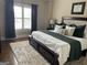 Cozy bedroom with large window, plush rug, and a comfortable bed with decorative pillows at 2220 Cambridge Hill Ct, Dacula, GA 30019