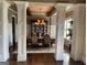 Formal dining room featuring hardwood floors and decorative columns, creating an elegant space at 2220 Cambridge Hill Ct, Dacula, GA 30019