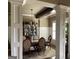 Formal dining room featuring wainscoting, elegant chandelier, and a view of the backyard at 2220 Cambridge Hill Ct, Dacula, GA 30019
