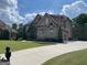 A well-maintained driveway leads to a brick home with an attached garage and landscaped front yard at 2220 Cambridge Hill Ct, Dacula, GA 30019