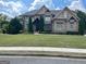 Beautiful brick home with lush lawn, tasteful shutters, and manicured landscaping at 2220 Cambridge Hill Ct, Dacula, GA 30019