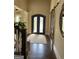 Inviting foyer with hardwood floors, decorative columns, and a view of the front door at 2220 Cambridge Hill Ct, Dacula, GA 30019