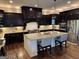 This kitchen showcases granite countertops, a large center island, stainless appliances, and dark wood cabinets at 2220 Cambridge Hill Ct, Dacula, GA 30019