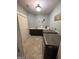 This laundry room features a sink, countertops, and modern washer and dryer at 2220 Cambridge Hill Ct, Dacula, GA 30019