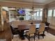 Open floor plan showcasing a dining area, stone fireplace, built-in shelving, and abundant natural light at 2220 Cambridge Hill Ct, Dacula, GA 30019
