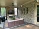 Inviting screened porch with a cozy seating area, a fireplace, and wooded views at 2220 Cambridge Hill Ct, Dacula, GA 30019