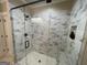 A glass shower enclosure with beautiful tilework and modern fixtures, perfect for a luxurious bathroom at 2220 Cambridge Hill Ct, Dacula, GA 30019