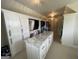 Well-organized walk-in closet with custom cabinetry, marble countertop island, and elegant lighting at 2220 Cambridge Hill Ct, Dacula, GA 30019