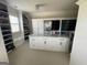 Spacious walk-in closet with custom storage, a marble-topped island, and natural light at 2220 Cambridge Hill Ct, Dacula, GA 30019