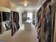 Large walk-in closet with custom shelving, center island, and ample storage space at 2220 Cambridge Hill Ct, Dacula, GA 30019