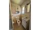 Bathroom featuring toilet, sink and cabinet, wallpaper, and a window at 363 Seminole Drs, Marietta, GA 30060