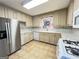 A functional kitchen with white cabinets, stainless steel refrigerator, and tile backsplash at 363 Seminole Drs, Marietta, GA 30060