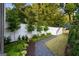 Professionally landscaped backyard with a manicured lawn, decorative rock path, and privacy fence at 490 Mount Paran Rd, Atlanta, GA 30327