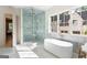 Luxury bathroom featuring a soaking tub, glass enclosed shower and a window at 490 Mount Paran Rd, Atlanta, GA 30327