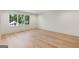 Spacious bedroom with hardwood floors and a large window overlooking lush greenery at 490 Mount Paran Rd, Atlanta, GA 30327
