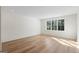 Light-filled room with hardwood floors, a large window, and neutral paint, creating a cozy atmosphere at 490 Mount Paran Rd, Atlanta, GA 30327