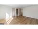 Bright room showcasing hardwood floors and neutral walls leading to a bathroom and hall area at 490 Mount Paran Rd, Atlanta, GA 30327