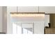 Close-up view of a modern chandelier fixture, with an art piece beneath at 490 Mount Paran Rd, Atlanta, GA 30327