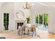 Bright dining area featuring a fireplace, modern lighting, and an outdoor patio at 490 Mount Paran Rd, Atlanta, GA 30327
