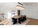 Bright dining room with stylish chandelier, modern art, and seating for six at 490 Mount Paran Rd, Atlanta, GA 30327