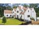 Elegant exterior showcasing a well-manicured front lawn and updated white facade with a classic roofline at 490 Mount Paran Rd, Atlanta, GA 30327