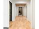 Hallway featuring hardwood floors, wooden beams, and views of a room with a potted plant at 490 Mount Paran Rd, Atlanta, GA 30327