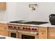 Oversized stainless steel range with red knobs and modern pot filler at 490 Mount Paran Rd, Atlanta, GA 30327