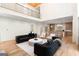 Open-concept living area adjacent to kitchen with hardwood floors and second story overlook at 490 Mount Paran Rd, Atlanta, GA 30327