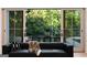 Cozy living room featuring a fireplace, a large sofa, and an outdoor view at 490 Mount Paran Rd, Atlanta, GA 30327