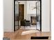 Elegant living room with steel doors, a fireplace, and an inviting seating area at 490 Mount Paran Rd, Atlanta, GA 30327