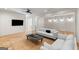 A bright and inviting living room with a ceiling fan, hardwood floors, and plush seating with neutral decor at 490 Mount Paran Rd, Atlanta, GA 30327