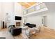 Bright open-concept living room with fireplace, hardwood floors, and second story overlook at 490 Mount Paran Rd, Atlanta, GA 30327