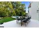 The patio features a spacious dining area with modern black table and chairs, with views overlooking the pool and backyard at 490 Mount Paran Rd, Atlanta, GA 30327