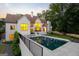 Stunning backyard featuring a pristine pool, lush landscaping, and a modern, white-painted brick home at 490 Mount Paran Rd, Atlanta, GA 30327