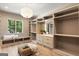 Walk in closet with shelving, drawers, bench seating and a large window at 490 Mount Paran Rd, Atlanta, GA 30327