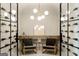 A wine cellar featuring a chandelier, display shelves, glass doors, and tile floors at 490 Mount Paran Rd, Atlanta, GA 30327
