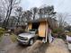 An exterior shot of a home's carport with a car inside and clutter around the perimeter at 2234 Glendale Dr, Decatur, GA 30032