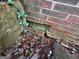 Exterior foundation of a house with a hole and some stone with a covering of leaves at 2234 Glendale Dr, Decatur, GA 30032
