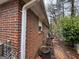 Exterior side of a brick house with foliage and view of part of the back yard at 2234 Glendale Dr, Decatur, GA 30032