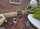 Home exterior featuring a low foundation vent and weathered yard debris at 2234 Glendale Dr, Decatur, GA 30032