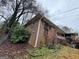 Exterior view of a brick house with green bushes in front of the home at 2234 Glendale Dr, Decatur, GA 30032