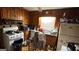 Kitchen featuring dated wood paneling and cabinets, along with older appliances and a cluttered space at 2234 Glendale Dr, Decatur, GA 30032